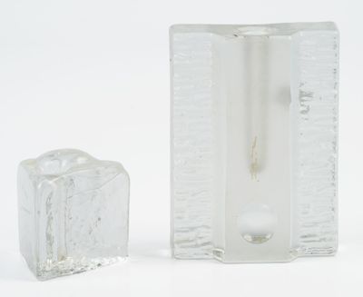 two pieces of ice sitting next to each other on a white surface