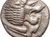 a silver coin with an image of a woman holding a child