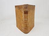 an old book sitting on top of a white table