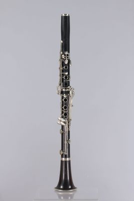 a black and silver clarinet sitting on top of a white table
