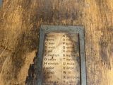 a plaque on the side of a wooden table