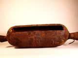 an old wooden container with a handle on a white surface