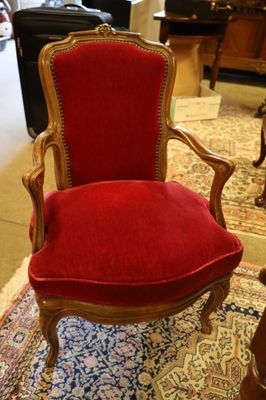a red chair that is on a rug in a room