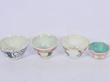 three small cups are sitting next to each other on a white surface
