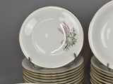 a lot of plates and cups sitting on top of each other