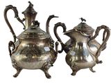 pair of antique silver plated teapots with ornate handles