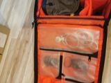 an open suitcase with many items in it on the floor