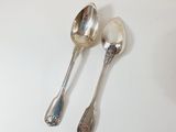 two spoons that are sitting on a table