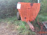 a rusted out dumpster sitting in the middle of a field