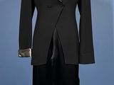 a black suit on a mannequin stand on a blue background