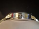 a close up of a watch on a white mannequin