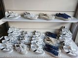 many pairs of shoes on a shelf in a store