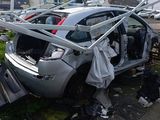 a car that has been smashed into pieces in a parking lot
