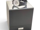 a watch sitting in a black box on a white surface