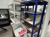 a room with shelves and bins in the middle of the room