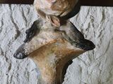 a statue of a bird sitting on top of a vase
