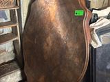 a large metal plate sitting on top of a wooden table