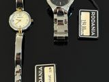 three watches are sitting on a table with tags attached to them