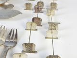 a lot of forks and spoons that are on a table