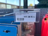 a label on the back of a red gas can in a store