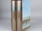 two books sitting on top of each other on a white surface