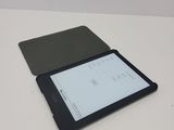 a tablet computer sitting on top of a white table