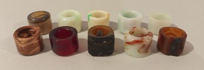 many different types of candles on a white surface