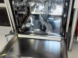a dishwasher that is open in a kitchen