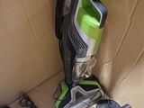 a vacuum that is sitting on the floor next to a box