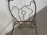 a metal chair that has a drawing on it