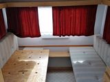 a couch and a table in the corner of a camper