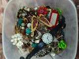 a plastic container filled with assorted items on a marble table