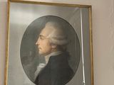 a painting of a man in a black suit on a wall