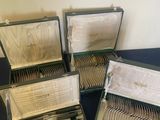 several silverware in a case sitting on a table next to a wall