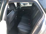 the back seat of a silver car with a black seat cover