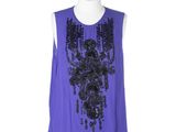 a purple top with black sequins and beads on a mannequin