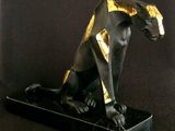 an image of a statue of an egyptian cat on a black base