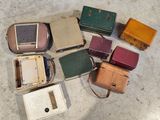 many different types of luggage sitting on the floor