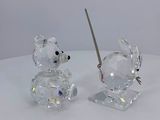 two crystal figurines of mice on a white table