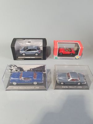 three boxed toy cars are sitting on a table next to each other