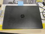 a laptop that is sitting on a table with a pen and paper