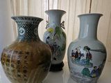three vases that are sitting on a table