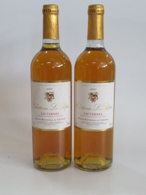 two bottles of wine sitting next to each other on a table