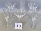 four empty wine glasses sitting next to each other on a table