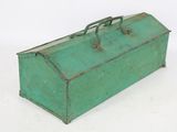 a green metal tool box sitting on a white surface