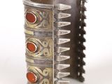 an image of a silver bracelet with red stones on a white background