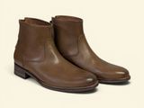a close up of a pair of brown boots on a white background