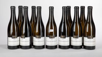 six bottles of wine are lined up in a row on a table