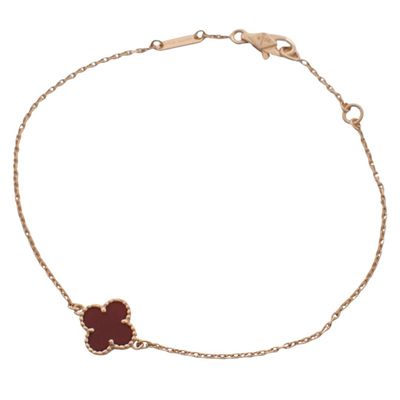 an image of a bracelet with a red flower on it