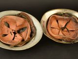 two bowls with a face on top of them on a table